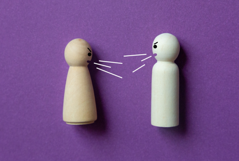 Two wood people yelling at each other