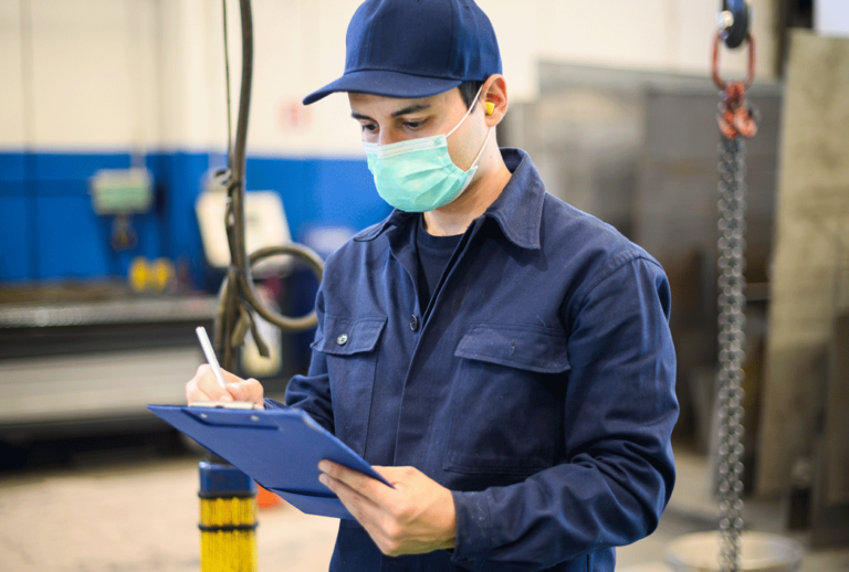 Man wearing a mask holding a clipboard
