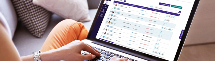 Person sitting on a couch, typing on a computer with screen image of Citation Canada, formerly HRdownloads, Platform