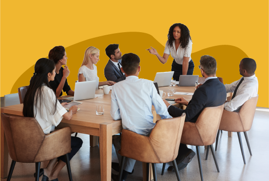 Group of people sitting around a table in a meeting