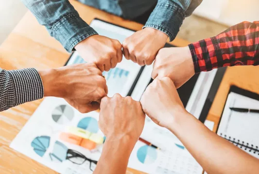 6 fists side by side in a circle