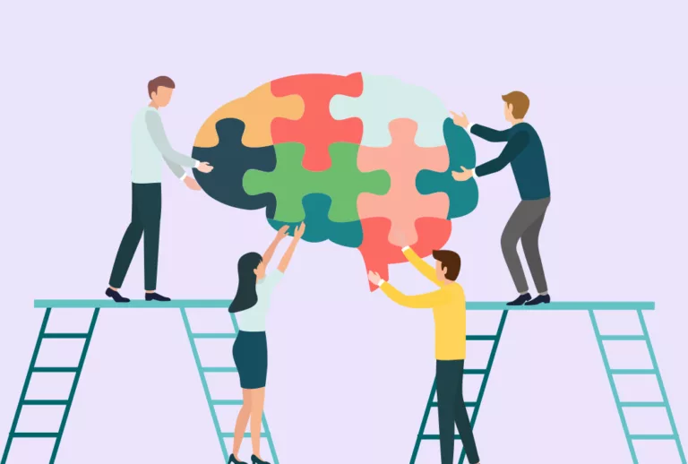 Employees on ladders putting puzzle pieces together to make an image of a brain