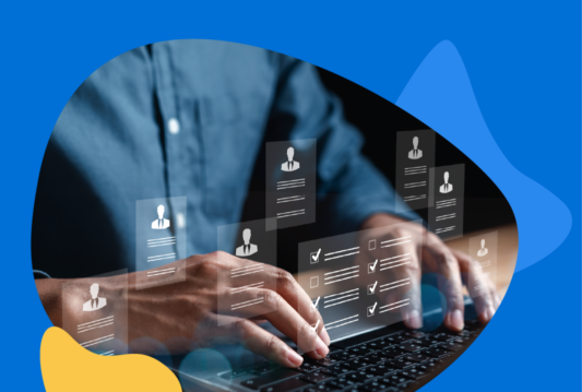 Man in blue collar dress shirt typing on keyboard