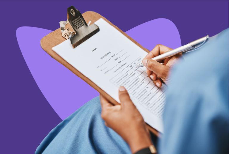 Person in scrubs holding a clipboard on lap and filling out a form.