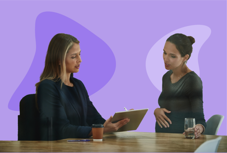 Pregnant employee with water discusses protected leave with her supervisor.