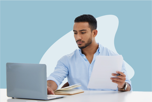 Man writing a written warning on a computer